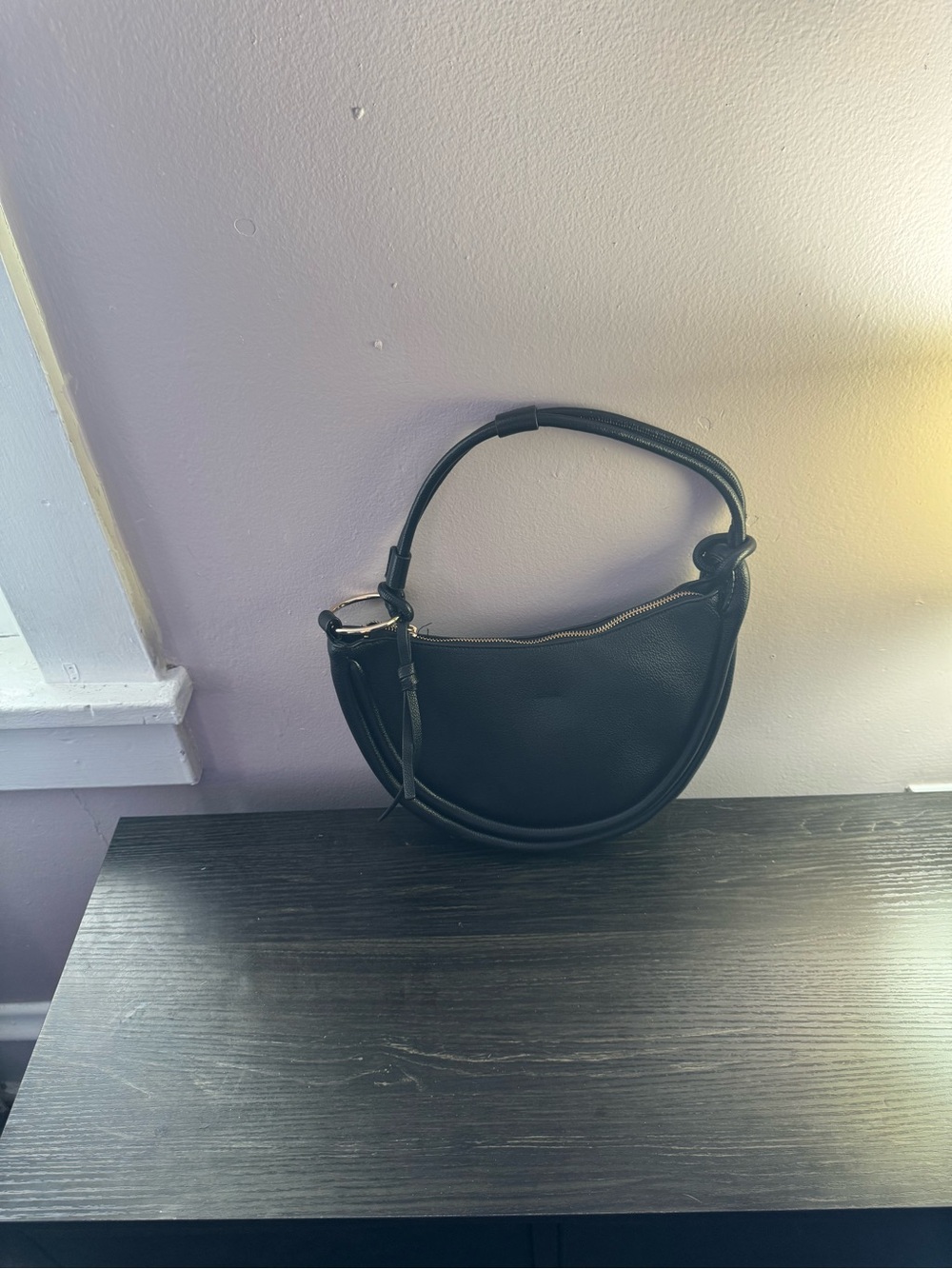 Curved Black Leather Shoulder Bag with Zip Closure